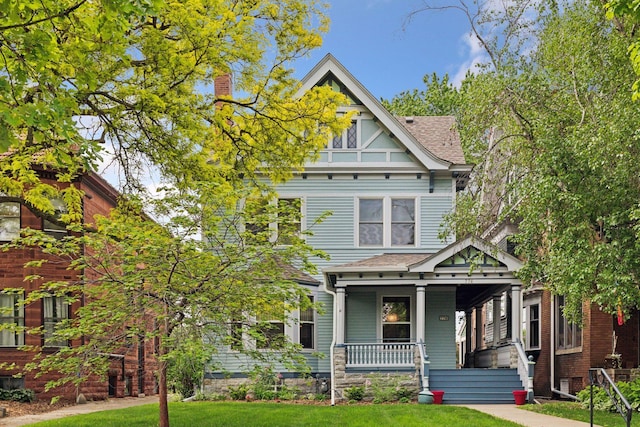 776 Summit Ave, Saint Paul, MN 55105 - view of front of home featuring covered porch, roof with shingles, and a front lawn