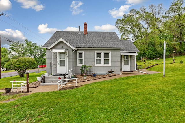 1313 Vine St, Le Sueur, MN 56058 - back of house featuring roof with shingles, a chimney, and a yard