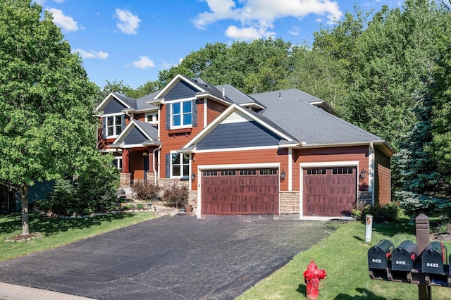 6415 Queensland Ln N, Maple Grove, MN 55311 - craftsman house with stone siding, an attached garage, a front yard, and asphalt driveway