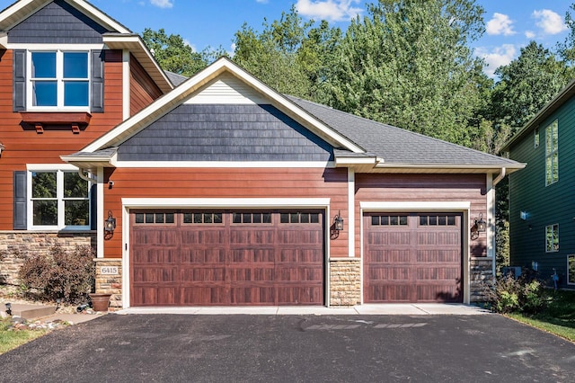 6415 Queensland Ln N, Maple Grove, MN 55311 - view of front of property with stone siding, asphalt driveway, and a garage