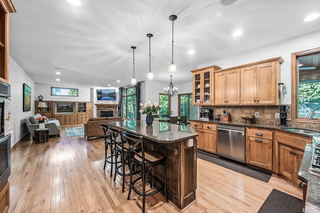 6415 Queensland Ln N, Maple Grove, MN 55311 - kitchen with dishwasher, a stone fireplace, a sink, a kitchen bar, and open floor plan