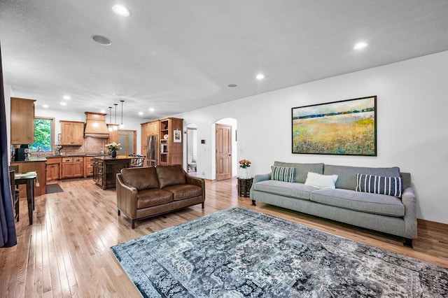 6415 Queensland Ln N, Maple Grove, MN 55311 - living room featuring arched walkways, light wood finished floors, recessed lighting, and baseboards