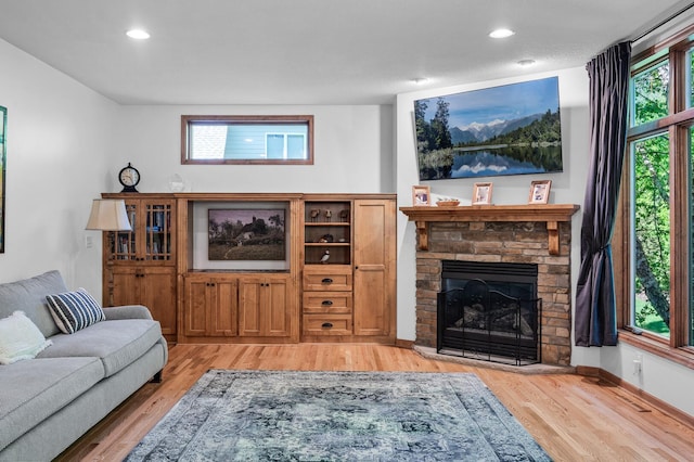 6415 Queensland Ln N, Maple Grove, MN 55311 - living room with light wood-style floors, a stone fireplace, recessed lighting, and baseboards