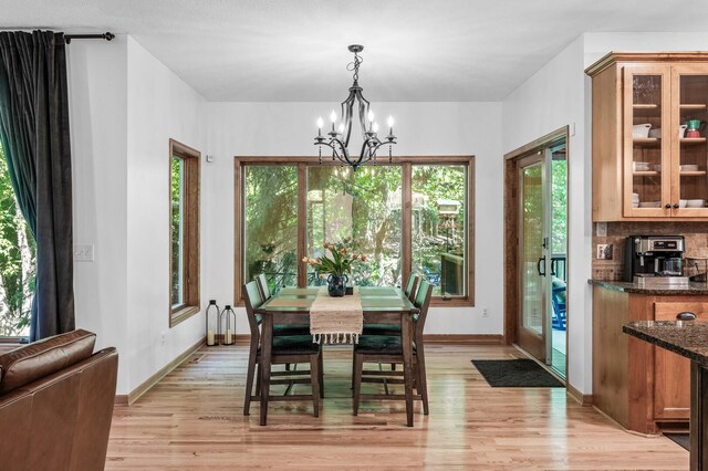 6415 Queensland Ln N, Maple Grove, MN 55311 - dining room with a chandelier, light wood-style flooring, and baseboards