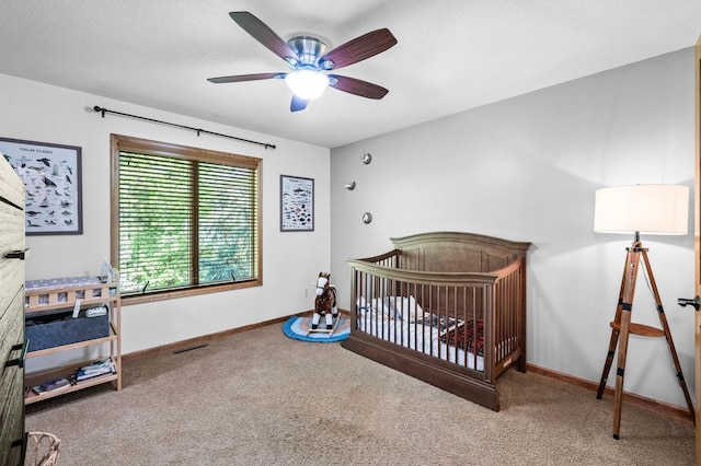 6415 Queensland Ln N, Maple Grove, MN 55311 - bedroom featuring carpet floors, baseboards, a ceiling fan, a nursery area, and a textured ceiling