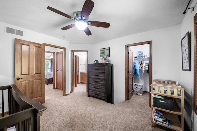 6415 Queensland Ln N, Maple Grove, MN 55311 - bedroom with a spacious closet, light colored carpet, a closet, ensuite bath, and a ceiling fan