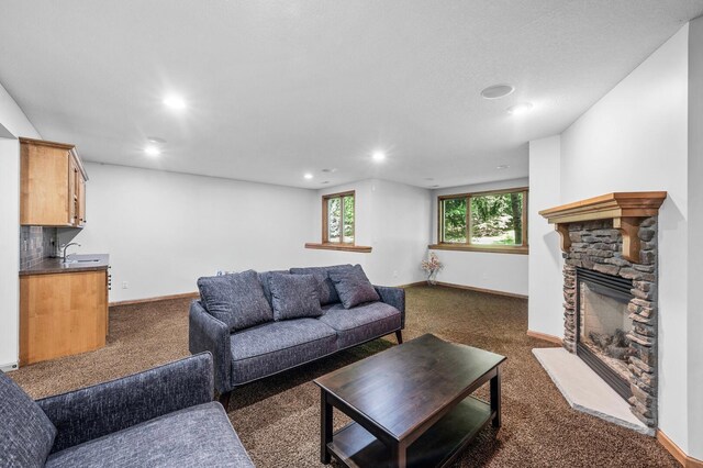 6415 Queensland Ln N, Maple Grove, MN 55311 - living area with dark carpet, recessed lighting, a fireplace, and baseboards