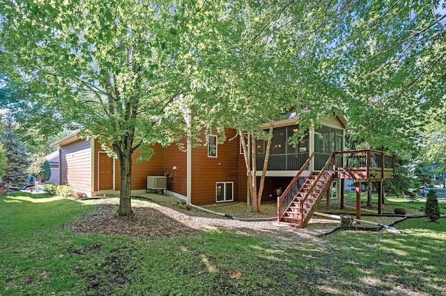 6415 Queensland Ln N, Maple Grove, MN 55311 - rear view of property featuring a sunroom, central AC unit, stairway, a yard, and a wooden deck
