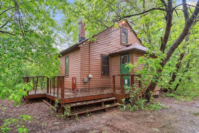 3032 County Road H2, Mounds View, MN 55112 - view of side of home featuring a chimney and a wooden deck
