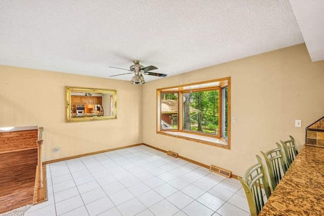 2216 146th Ave NE, Ham Lake, MN 55304 - unfurnished dining area featuring a ceiling fan and a textured ceiling