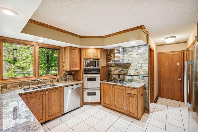 2216 146th Ave NE, Ham Lake, MN 55304 - kitchen featuring wall chimney exhaust hood, appliances with stainless steel finishes, crown molding, brown cabinetry, and backsplash