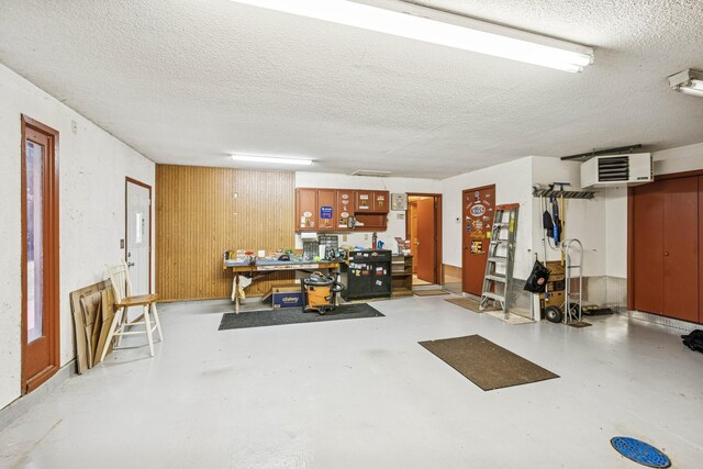 2216 146th Ave NE, Ham Lake, MN 55304 - below grade area with a textured ceiling, a heating unit, and a workshop area