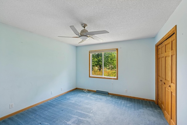 2216 146th Ave NE, Ham Lake, MN 55304 - unfurnished bedroom featuring carpet floors, ceiling fan, and a textured ceiling