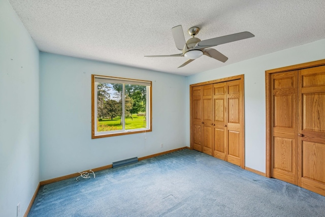 2216 146th Ave NE, Ham Lake, MN 55304 - unfurnished bedroom with carpet flooring, a textured ceiling, and a ceiling fan