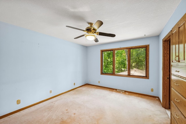 2216 146th Ave NE, Ham Lake, MN 55304 - unfurnished bedroom featuring light colored carpet, ceiling fan, and a textured ceiling