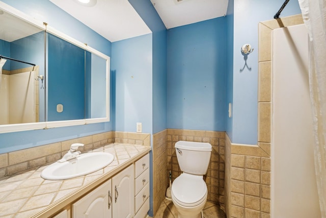 2216 146th Ave NE, Ham Lake, MN 55304 - full bathroom featuring tile walls, vanity, wainscoting, and a shower with curtain