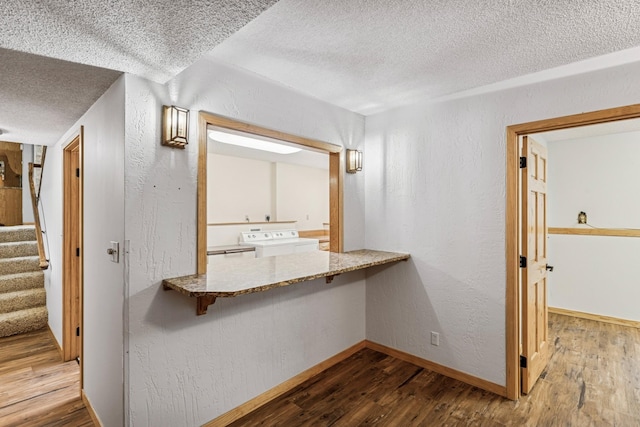 2216 146th Ave NE, Ham Lake, MN 55304 - hall featuring washer / dryer, a textured ceiling, wood finished floors, a textured wall, and stairway