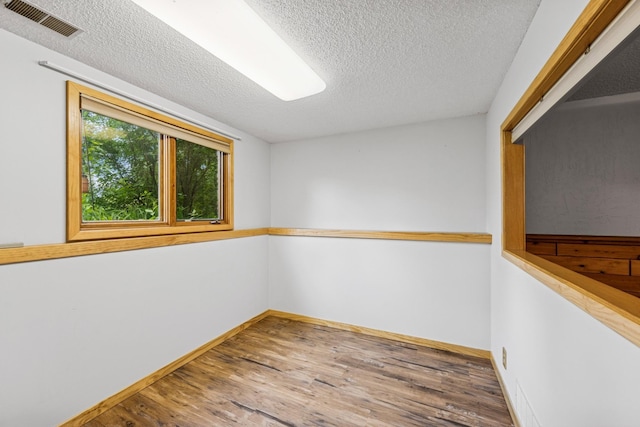 2216 146th Ave NE, Ham Lake, MN 55304 - spare room with a textured ceiling and wood finished floors