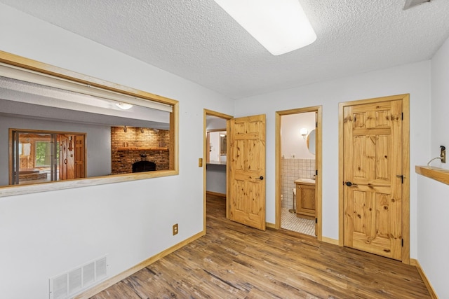 2216 146th Ave NE, Ham Lake, MN 55304 - empty room with wood finished floors and a textured ceiling