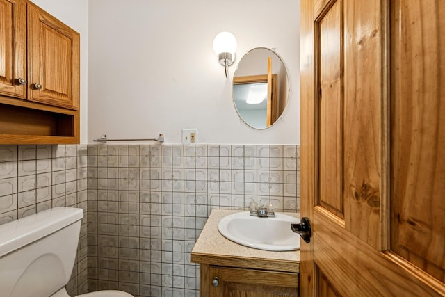2216 146th Ave NE, Ham Lake, MN 55304 - bathroom featuring tile walls, vanity, and a wainscoted wall