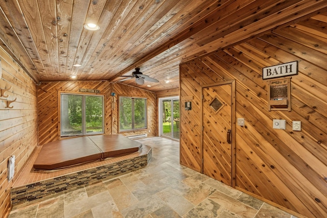 2216 146th Ave NE, Ham Lake, MN 55304 - hallway with wooden ceiling, wooden walls, stone tile floors, and lofted ceiling