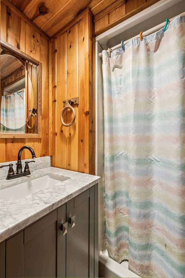 2216 146th Ave NE, Ham Lake, MN 55304 - full bathroom featuring vanity, wooden ceiling, wood walls, and shower / tub combo