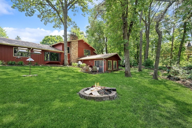 2216 146th Ave NE, Ham Lake, MN 55304 - view of grassy yard featuring an outdoor fire pit and an outbuilding