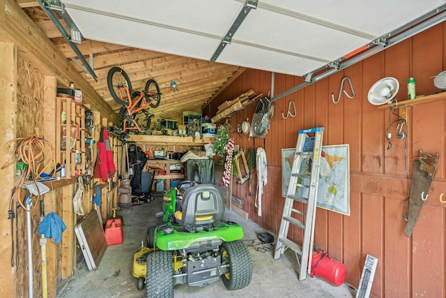 2216 146th Ave NE, Ham Lake, MN 55304 - garage featuring wooden walls and a workshop area