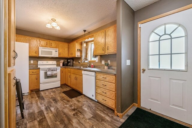 360 12th St NE, Milaca, MN 56353 - kitchen with white appliances, a sink, dark wood-style flooring, and a textured ceiling