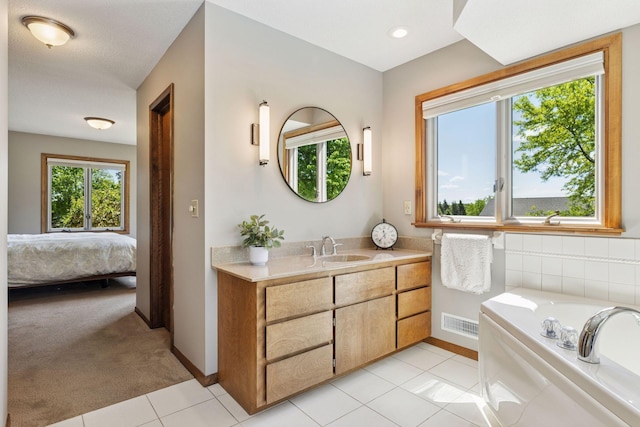 15905 43rd Ave N, Plymouth, MN 55446 - ensuite bathroom with vanity, a bath, baseboards, and tile patterned floors