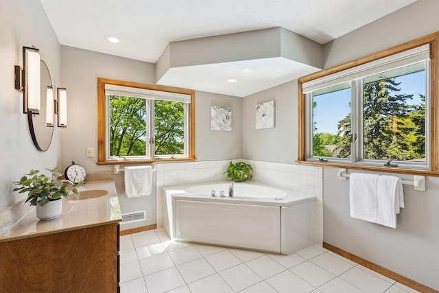 15905 43rd Ave N, Plymouth, MN 55446 - bathroom with healthy amount of natural light, vanity, a bath, tile patterned flooring, and recessed lighting