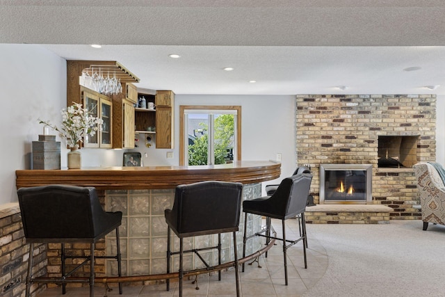 15905 43rd Ave N, Plymouth, MN 55446 - indoor bar with a textured ceiling, a fireplace, recessed lighting, and carpet floors