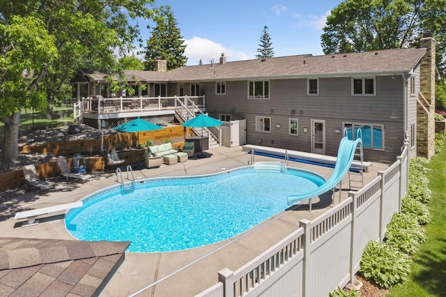 15905 43rd Ave N, Plymouth, MN 55446 - view of swimming pool featuring a water slide, a deck, a patio, an outdoor hangout area, and a diving board