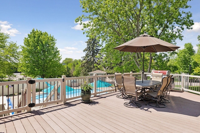 15905 43rd Ave N, Plymouth, MN 55446 - wooden terrace with outdoor dining space and view of wooded area