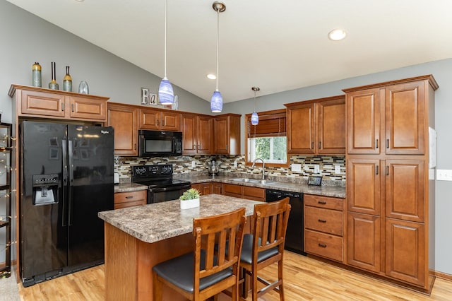 1436 Tunbridge Pl NE, Byron, MN 55920 - kitchen featuring black appliances, a sink, light wood-style flooring, and vaulted ceiling