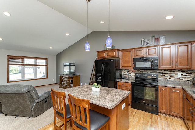 1436 Tunbridge Pl NE, Byron, MN 55920 - kitchen featuring black appliances, open floor plan, vaulted ceiling, brown cabinetry, and a kitchen island