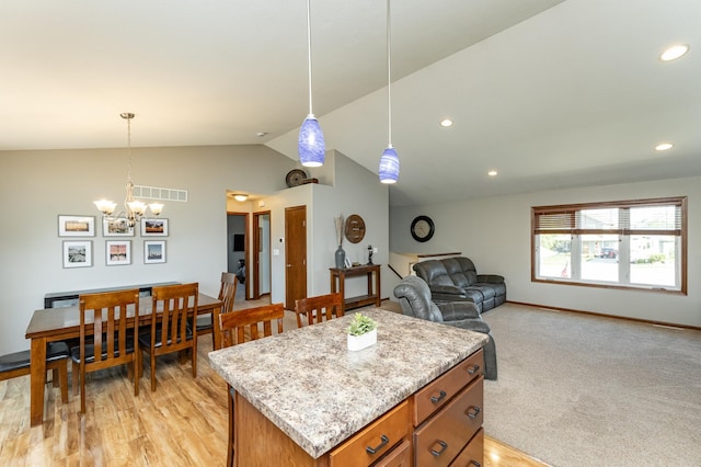 1436 Tunbridge Pl NE, Byron, MN 55920 - kitchen with vaulted ceiling, a chandelier, brown cabinetry, a kitchen island, and decorative light fixtures