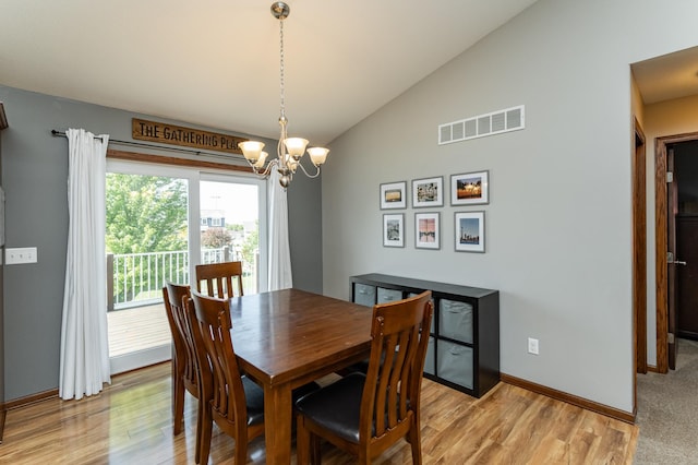 1436 Tunbridge Pl NE, Byron, MN 55920 - dining area featuring lofted ceiling, a chandelier, light wood-style flooring, and baseboards