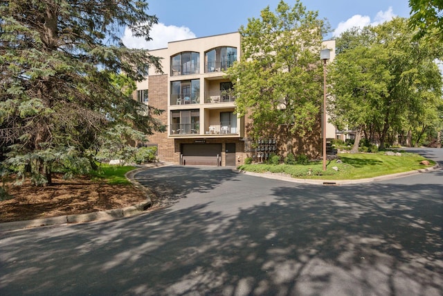 20 Windsor Ln Unit 213A, New Brighton, MN 55112 - view of apartment building / complex featuring a garage and asphalt driveway