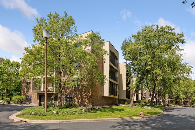 20 Windsor Ln Unit 213A, New Brighton, MN 55112 - view of property featuring a garage and asphalt driveway