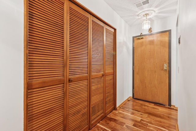 20 Windsor Ln Unit 213A, New Brighton, MN 55112 - hallway featuring wood finished floors and a textured ceiling