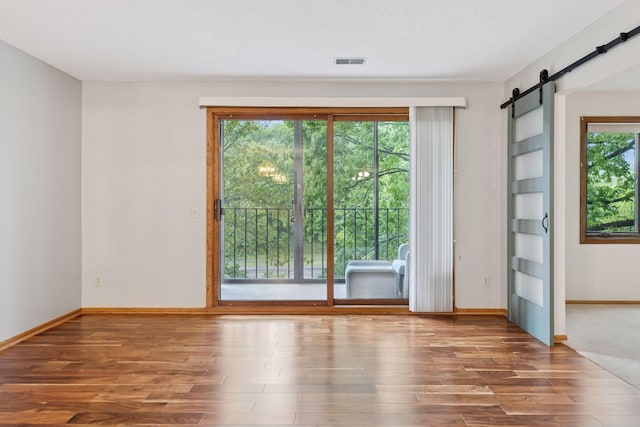 20 Windsor Ln Unit 213A, New Brighton, MN 55112 - empty room featuring wood finished floors, a barn door, and baseboards