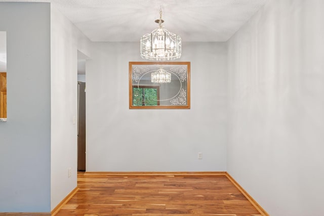 20 Windsor Ln Unit 213A, New Brighton, MN 55112 - spare room with a chandelier, wood finished floors, and baseboards