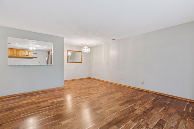 20 Windsor Ln Unit 213A, New Brighton, MN 55112 - empty room with wood finished floors, a chandelier, and baseboards
