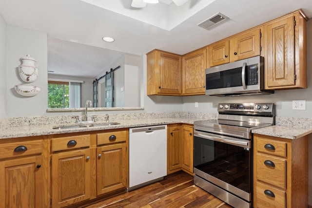 20 Windsor Ln Unit 213A, New Brighton, MN 55112 - kitchen with appliances with stainless steel finishes, a sink, dark wood-style floors, light stone countertops, and recessed lighting