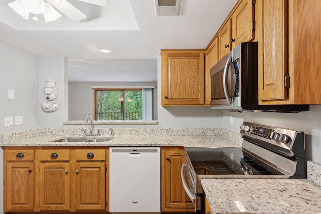 20 Windsor Ln Unit 213A, New Brighton, MN 55112 - kitchen with appliances with stainless steel finishes, a sink, a ceiling fan, brown cabinets, and light stone countertops