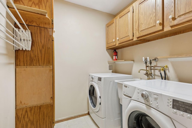 20 Windsor Ln Unit 213A, New Brighton, MN 55112 - laundry area featuring independent washer and dryer, cabinet space, baseboards, and light tile patterned floors