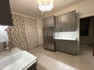 2204 Girard Ave S, Minneapolis, MN 55405 - kitchen with freestanding refrigerator, light countertops, and a chandelier