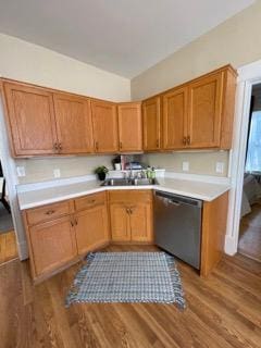 2204 Girard Ave S, Minneapolis, MN 55405 - kitchen with stainless steel dishwasher, light countertops, wood finished floors, and brown cabinetry