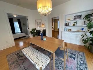 2204 Girard Ave S, Minneapolis, MN 55405 - dining room featuring a chandelier and wood finished floors